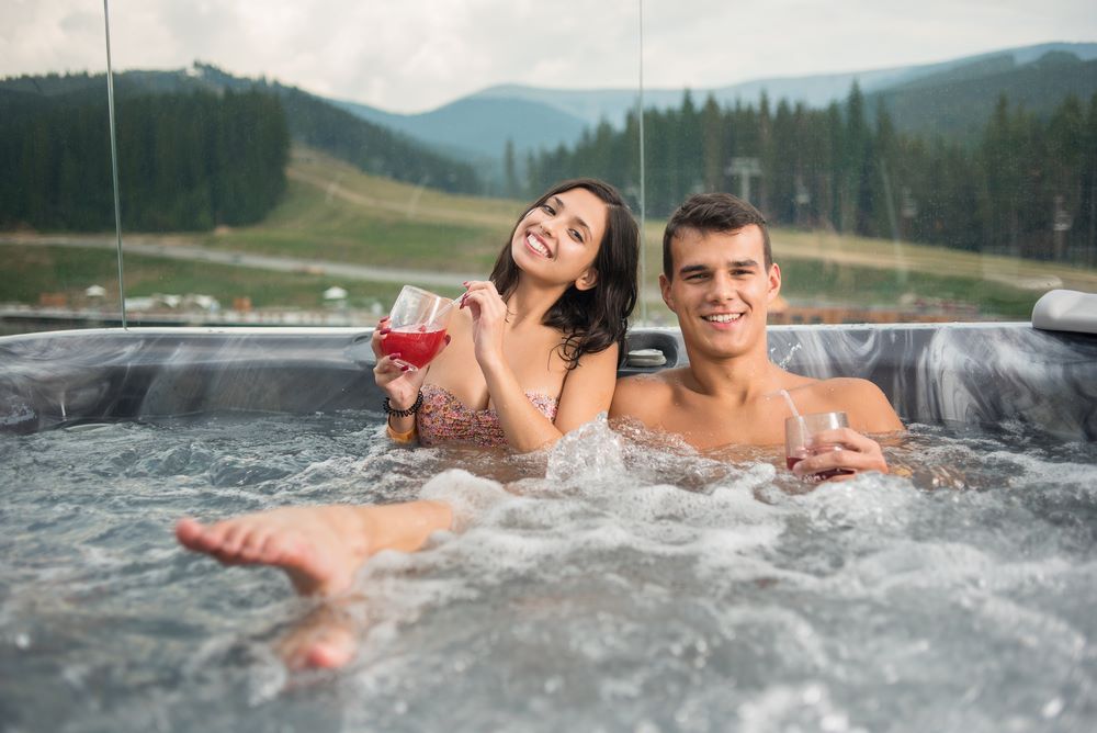 couple in a spa pool drinking wine