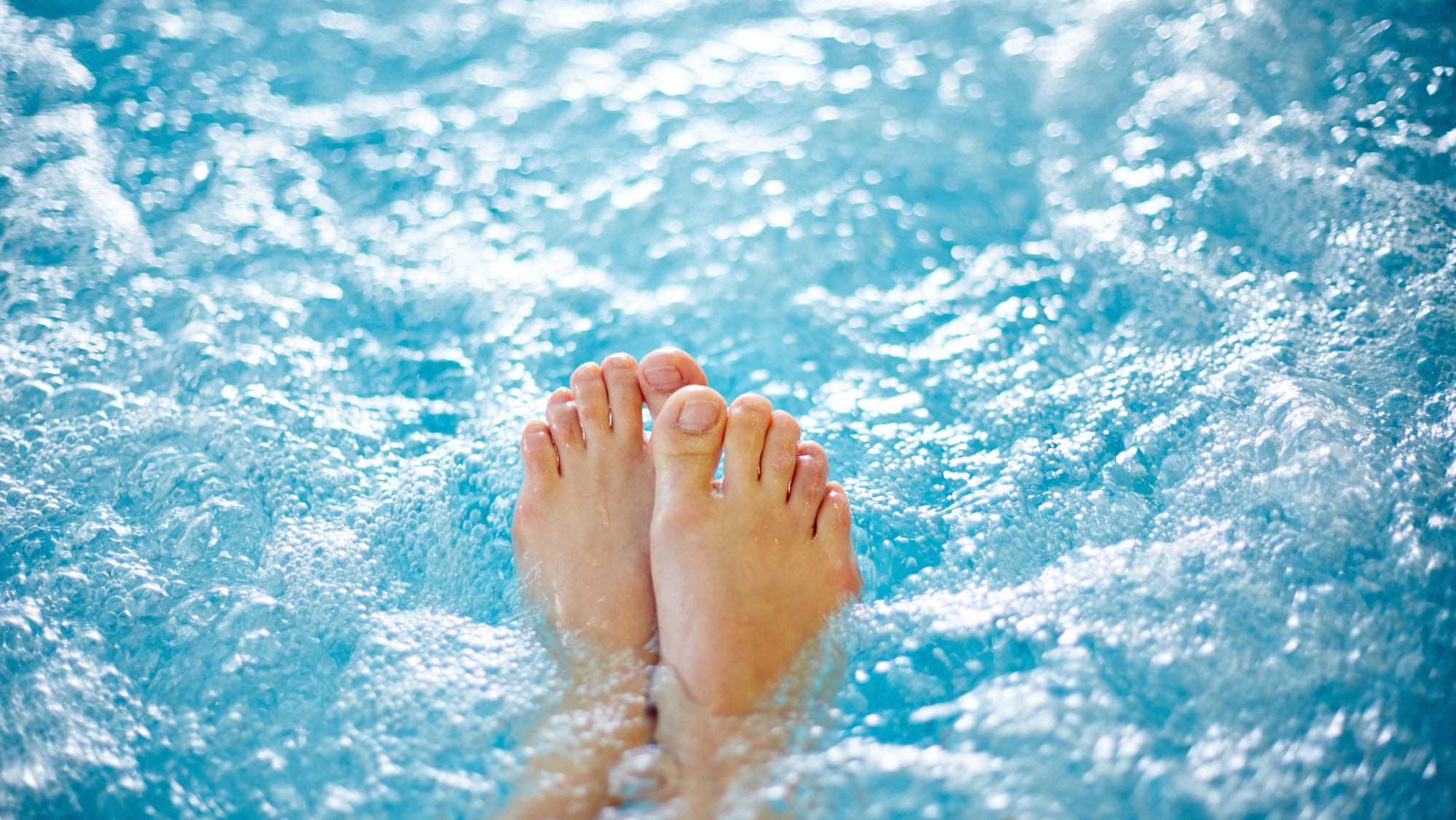 Feet in bubble spa pool
